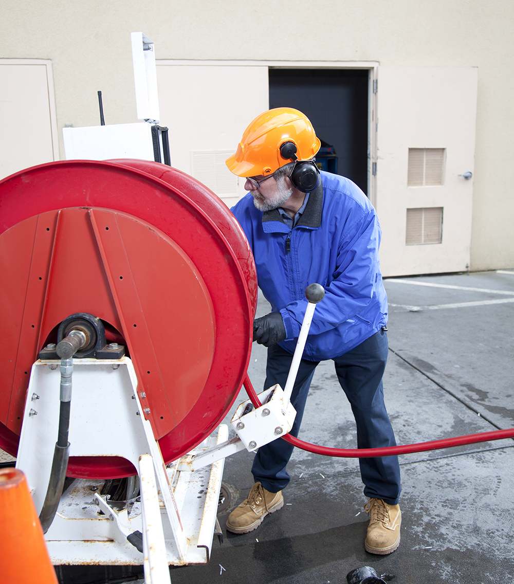 A man Hydro Line Jetting a Pipe